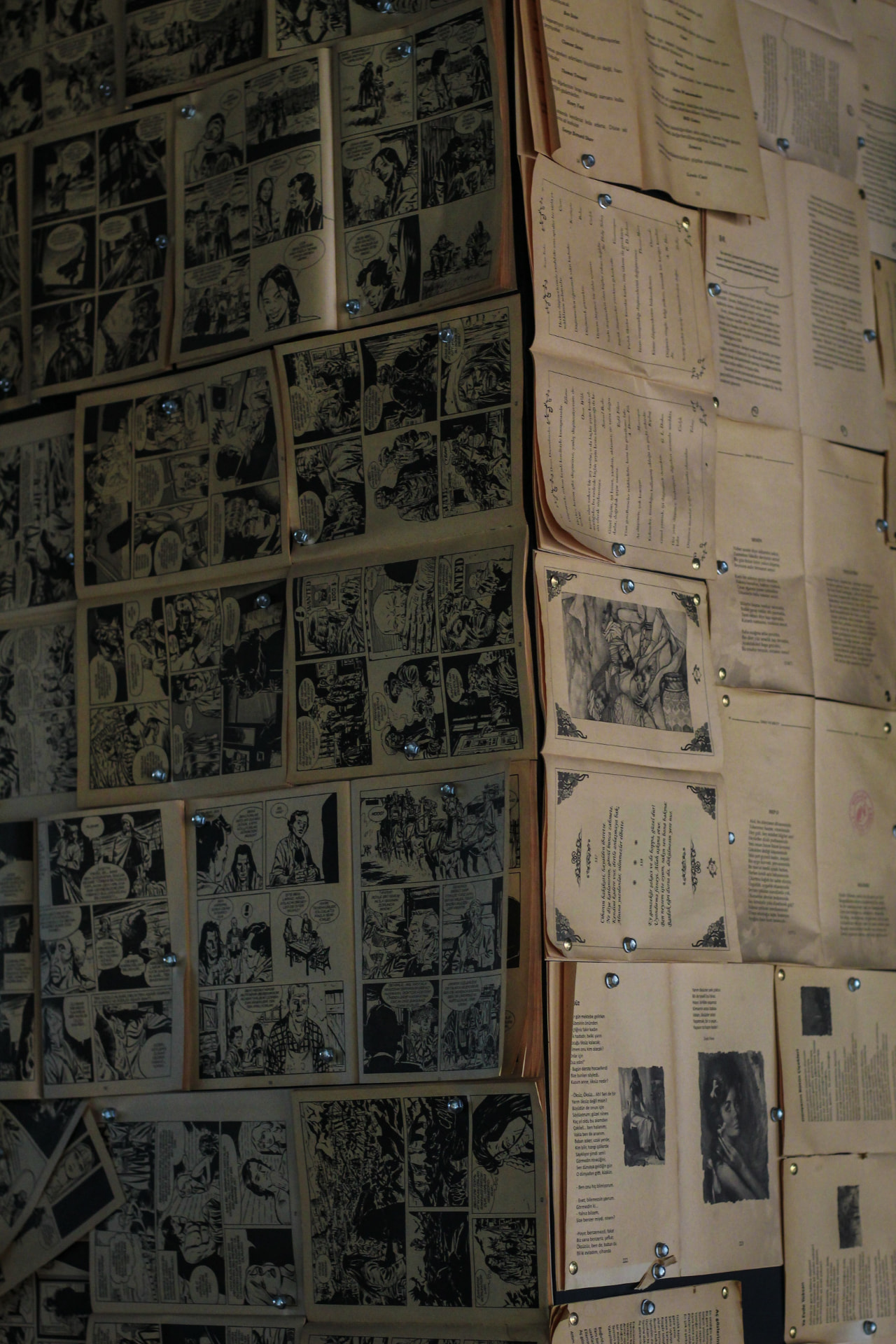 Vintage comic pages pinned to a studio wall